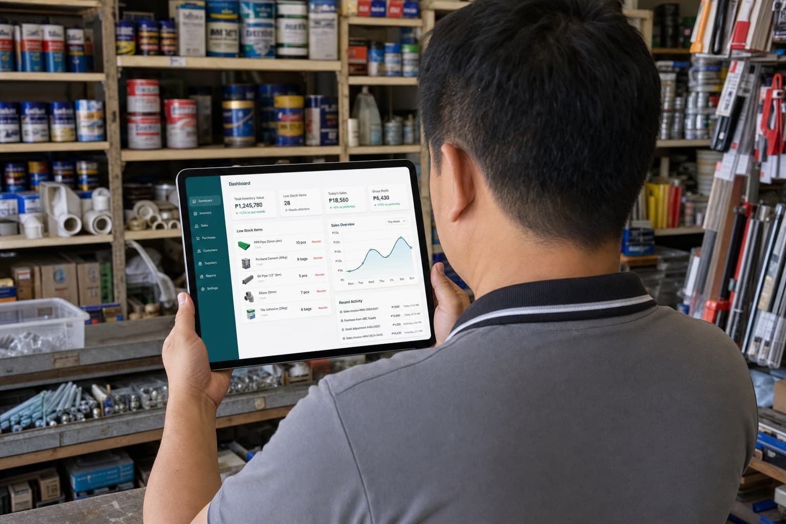 Over-the-shoulder view of a Filipino hardware store owner reviewing the Serotre inventory dashboard on a tablet